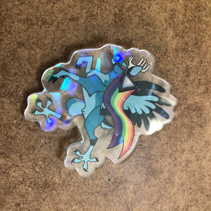 Pride Peryton, a holo acrylic pin featuring a peryton (deer/bird hybrid) holding the Progress Pride flag. Pride Peryton, a holo acrylic pin featuring a peryton (deer/bird hybrid) holding the Progress Pride flag.