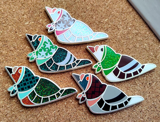 Birdbushka Set 2, a set of hard enamel pins depicting pigeons wearing babushka-style head scarves.